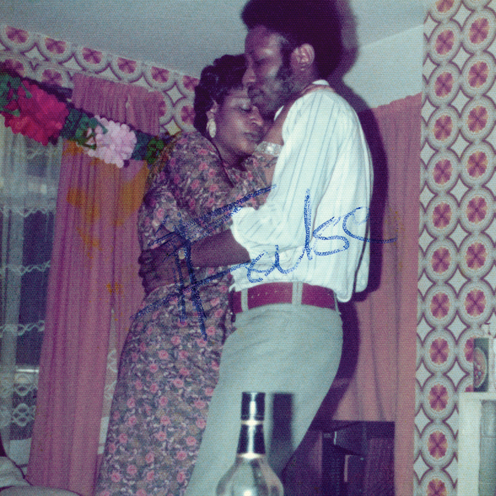 A photograph of a couple embracing in a domestic setting. They stand chest-to-chest, eyes closed, appearing very much in love. The image has been defaced with the word “False” written in the middle of the photograph